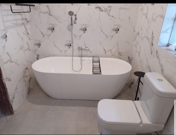Modern bathroom with freestanding bathtub and marble tiles